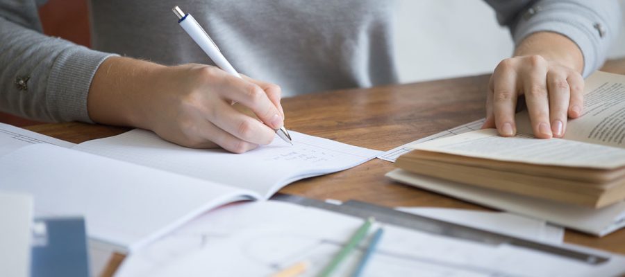 student-female-hands-performing-written-task-copybook